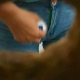 A woman is observed taking a shit into a floor toilet and then wiping herself from a hole-in-the-wall perspective. Over 2 minutes.